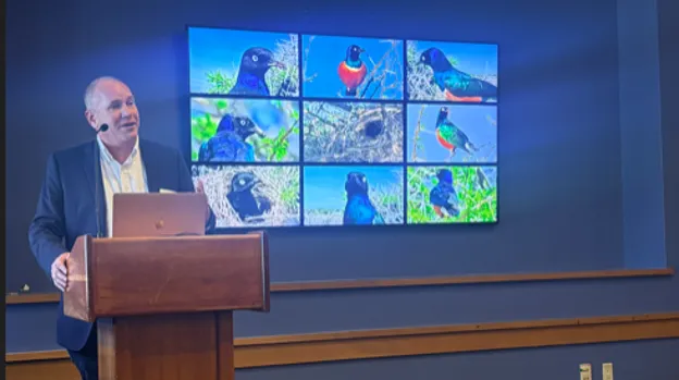 Photo of Professor Dustin Rubenstein and the subject of his project: the superb starling